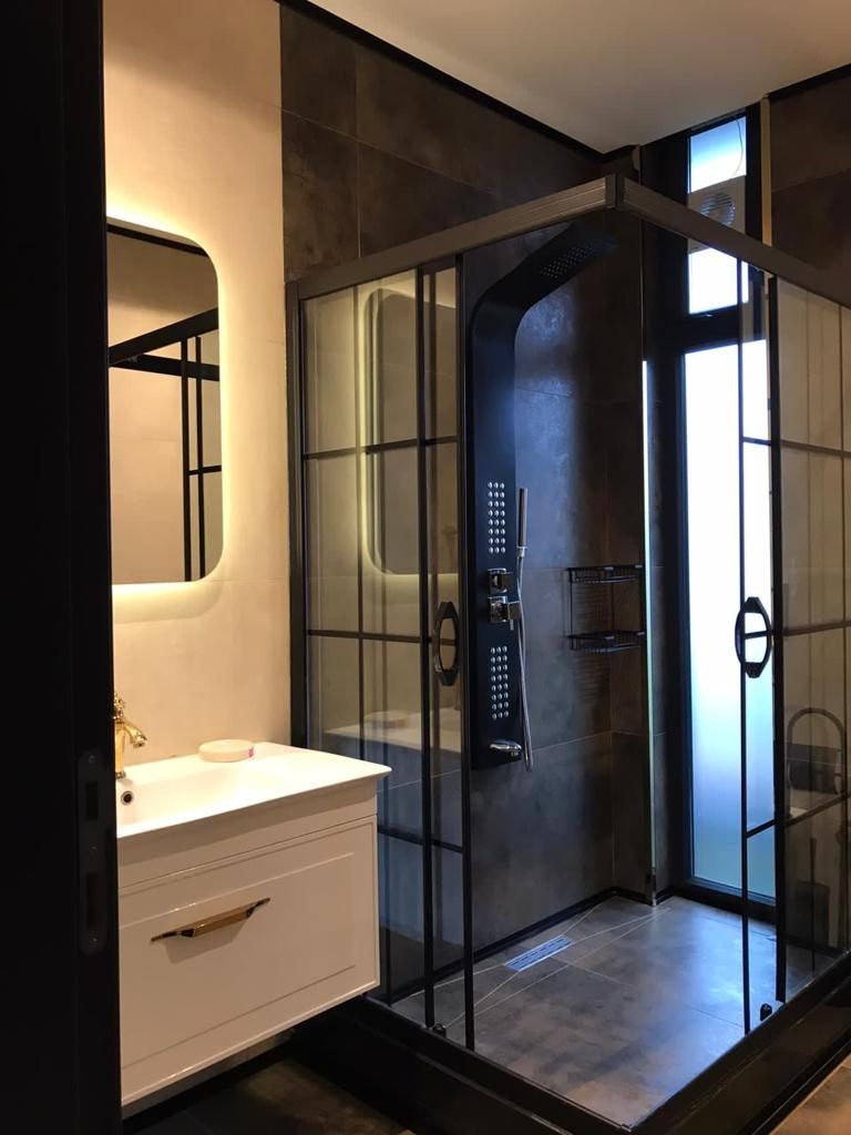 Bathroom with framed glass shower enclosure